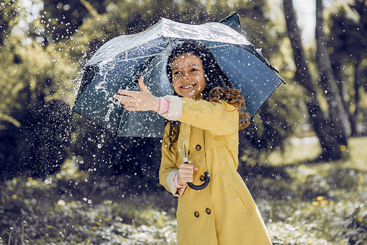 Cute kid plaiyng on a rainy day