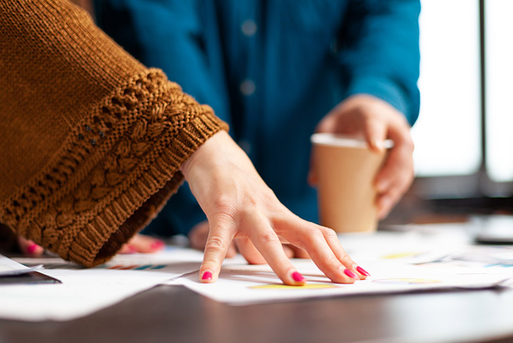 Closeup of businesspeople hands analyzing management documents working at company presentation